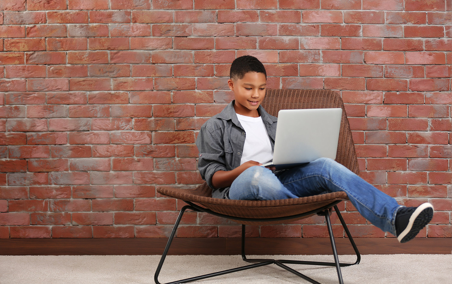 Brainline learner doing online schooling on laptop